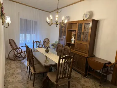a dining room with a table and chairs and a chandelier at A R Benjamín in Artana