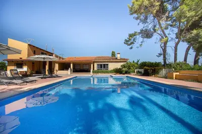 a large swimming pool in front of a house at Villa Azahar - Piscina - Barbacoa - Naturaleza in Valencia