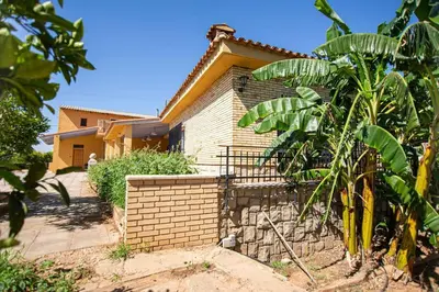 a house with a brick fence in front of it at Villa Azahar - Piscina - Barbacoa - Naturaleza in Valencia