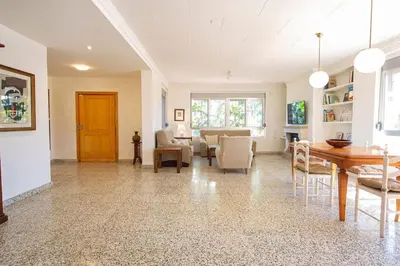 a living room with a table and chairs at Villa Azahar - Piscina - Barbacoa - Naturaleza in Valencia