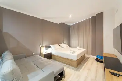 a hotel room with a bed and a couch at Albufera Dreams Nature Suites in Valencia