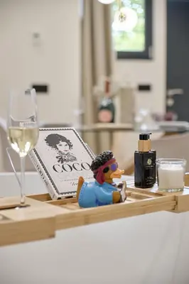 a toy rubber duck sitting on a table with a glass of wine at Romantic Apartment N1 Oceanografico Virkin Suites in Valencia