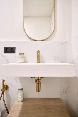 a bathroom with a sink and a mirror at Romantic Apartment N1 Oceanografico Virkin Suites in Valencia