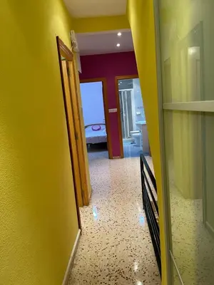 a hallway with a door open to a room at Casa JUANES in Cullera