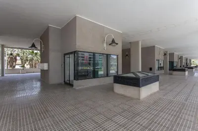 a large empty room with a lobby with windows at ApartUP Patacona Palm Beach II in Valencia