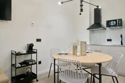 a dining room with a table and chairs in a kitchen at Romantic Apartment N5 Oceanografico Virkin Suites in Valencia