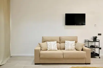 a couch with two pillows in a living room at Romantic Apartment N5 Oceanografico Virkin Suites in Valencia