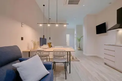 a dining room and living room with a table and chairs at Romantic Apartment N6 Oceanografico Virkin Suites in Valencia