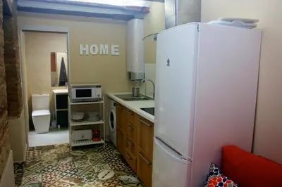 a kitchen with a white refrigerator and a microwave at Loft bajo vivienda centro de Valencia-Carmen in Valencia