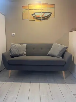 a blue couch in a room with paintings on the wall at Loft bajo vivienda centro de Valencia-Carmen in Valencia