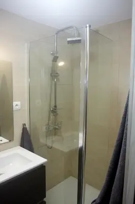 a shower with a glass door next to a sink at Loft bajo vivienda centro de Valencia-Carmen in Valencia