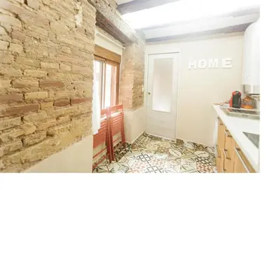 a kitchen with a brick wall and a counter top at Loft bajo vivienda centro de Valencia-Carmen in Valencia