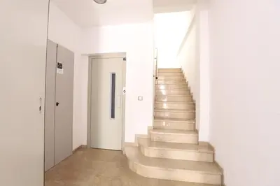 a staircase in a building with white walls and white floors at Tranquilo y delicioso rincón junto al mar in Puerto de Sagunto