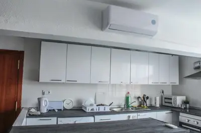 a white kitchen with white cabinets and a sink at Flat close to beach perfect for families and groups - Actor Mauri 18 in Valencia