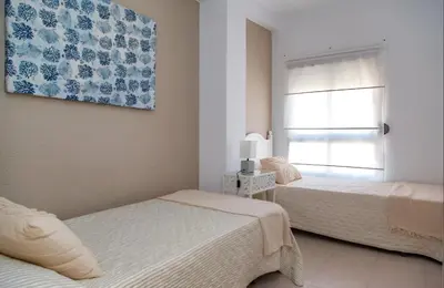 a bedroom with two beds and a window at Apartamento Premium frente al mar, en primera linea de playa in Cullera
