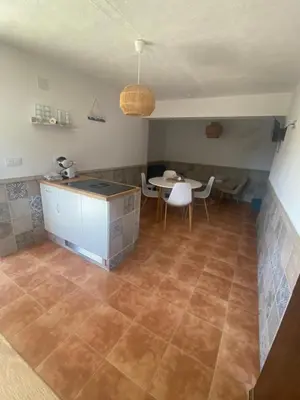 a kitchen with a counter and a table in a room at Rey Elzinga in Godelleta
