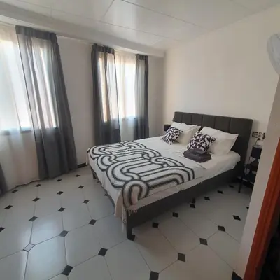 a bedroom with a bed with a black and white comforter at Casa Central in Cullera