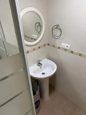 a bathroom with a sink and a mirror at ISABEL Apartment in Puerto de Sagunto