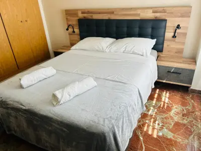 a bedroom with a large bed with two pillows on it at ISABEL Apartment in Puerto de Sagunto