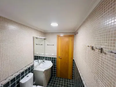 a bathroom with a toilet and a sink and a mirror at ISABEL Apartment in Puerto de Sagunto