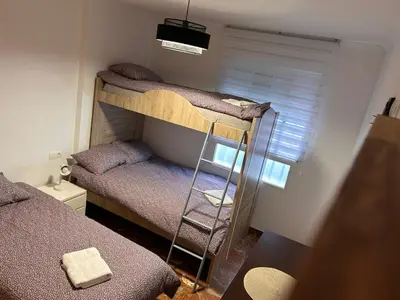 a room with two bunk beds and a window at ISABEL Apartment in Puerto de Sagunto