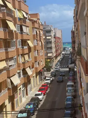a city street with cars parked on the side of the road at Mar y Puerto in Puerto de Sagunto