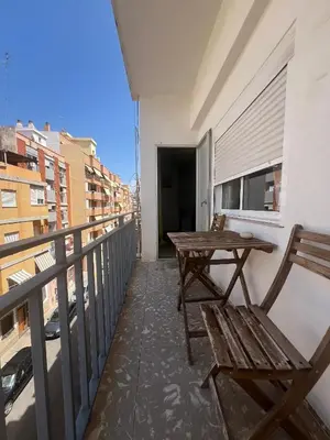 a balcony with a table and chairs on a building at Mar y Puerto in Puerto de Sagunto