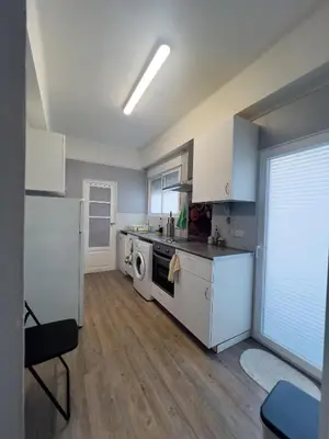 a kitchen with white cabinets and a stove top oven at Mar y Puerto in Puerto de Sagunto