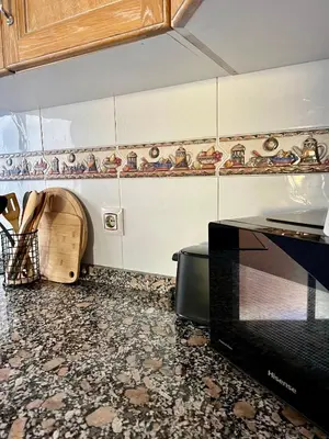 a kitchen with a counter top and a microwave at Cozy Flat with City & Beach in Puerto de Sagunto