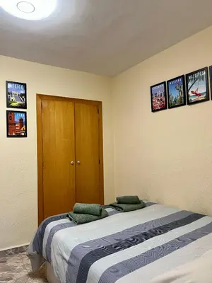 a bedroom with a bed and pictures on the wall at Cozy Flat with City & Beach in Puerto de Sagunto