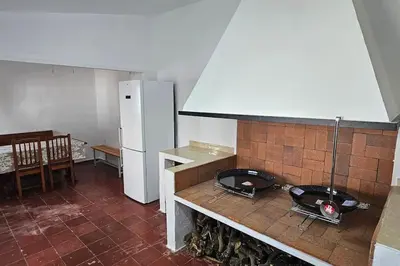 a kitchen with a counter and a refrigerator in it at casa imperial in Tous