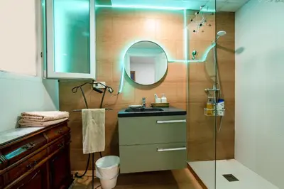 a bathroom with a sink and a shower with a mirror at Mirador 5 del Mercado Central - habitacion con baño privado en el centro de la Ciudad Vella in Valencia
