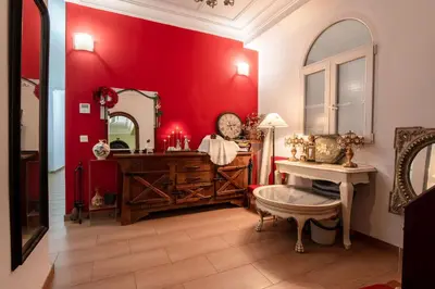 a red bathroom with a vanity and a mirror at Mirador 5 del Mercado Central - habitacion con baño privado en el centro de la Ciudad Vella in Valencia
