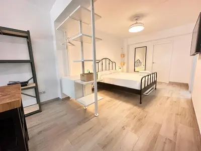 a room with a bed and shelves in it at Alberola Industrial Style in Valencia