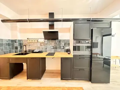 a kitchen with stainless steel appliances and a wooden counter top at Alberola Industrial Style in Valencia