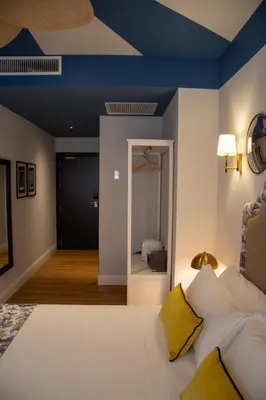 a bedroom with a blue ceiling and a mirror at Maison Primado B&B in Valencia