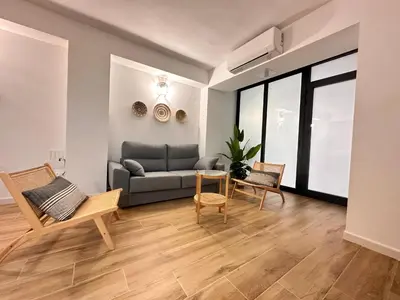 a living room with a couch and a table and chairs at Valencia & Suites Ayora in Valencia