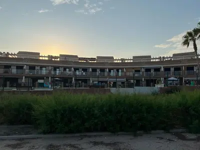 a building with a palm tree in front of it at Almenara, primera linea de playa VT-45077-CS in Almenara