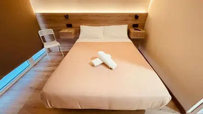 a bed with two towels on it in a room at OPTIMUS COMFORT Campoamor 101 in Valencia