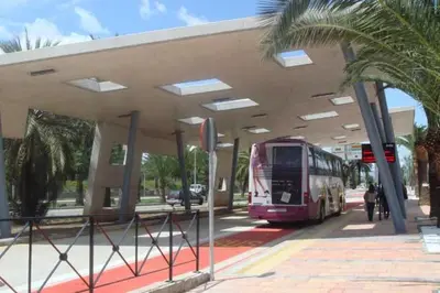 a bus is parked at a bus stop at ALZIRA BONiTA LES BARRAQUES LOFT in Alzira