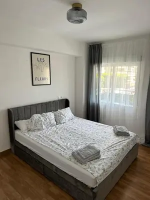 a bed with two towels on it in a bedroom at Seashell apartment in Cullera in Cullera