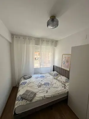 a bedroom with a bed in a room with a window at Seashell apartment in Cullera in Cullera