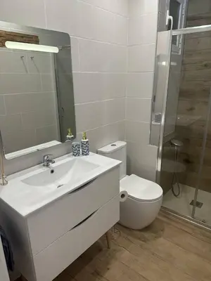 a bathroom with a white sink and a toilet at Seashell apartment in Cullera in Cullera