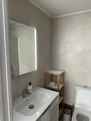a bathroom with a sink and a mirror and a toilet at Del Mar 1A - New Beach First floor apartment in Puerto de Sagunto