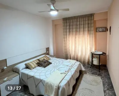 a bedroom with a large bed in a room at Apartamento en la Sierra Espadan in Artana