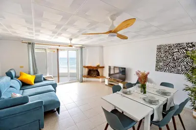 a living room with a blue couch and a table at ViDa MaLu - Housevanlive in Sueca