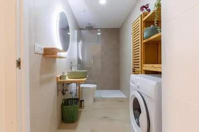 a bathroom with a sink and a washing machine at Loft nuevo cerca de Ruzafa y Ciudad de las Artes in Valencia