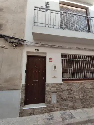 a building with a brown door and a balcony at Ca Salamandra in Albalat de Taronchers