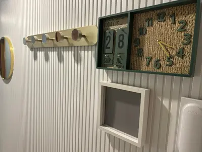 a clock and a mirror on a wall at Cullera Beach Oasis in Cullera