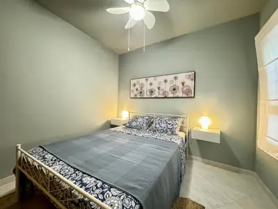 a bedroom with a bed and a ceiling fan at Cullera Beach Oasis in Cullera